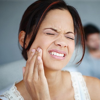 Woman holding jaw in pain