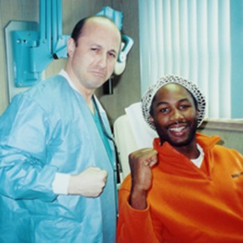 Dr. DeMartino posing with Lennox Lewis