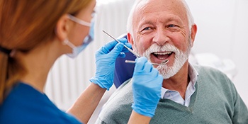 Man smiles at dentist