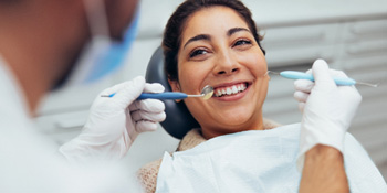 Patient smiling at dentist during exam