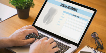 Patient looking at dental information form on computer