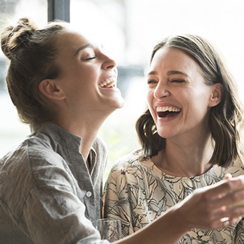 Two young women laughing together