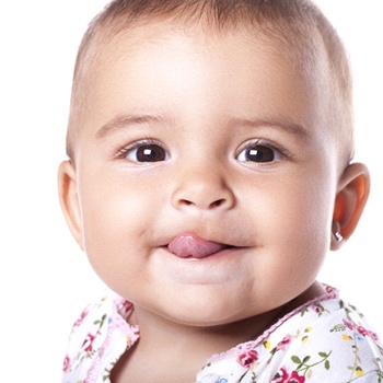 A young baby with its tongue out