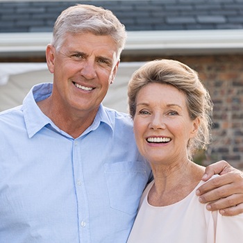 Older man and woman smiling outdoors