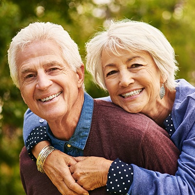 Smiling older couple with dental implants in Phillipsburg