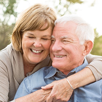 Smiling older man and woman outdoors