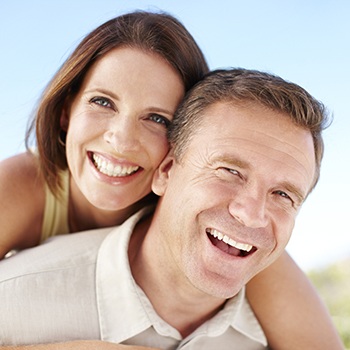 Smiling woman and man outdoors