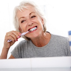 Woman brushing teeth in Phillipsburg