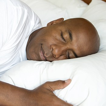 Man sleeping soundly in bed