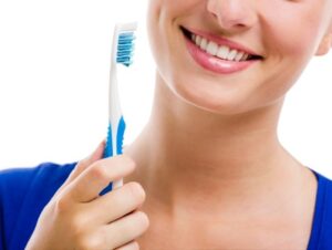 Smiling woman holding a toothbrush