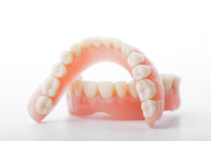 Upper and lower denture on white background