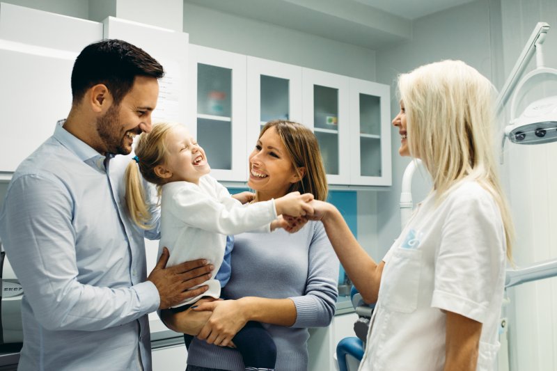 A family smiling after family dentistry