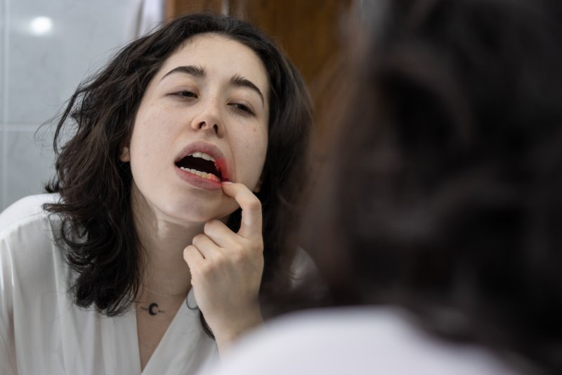 Woman checking her gum bumps in the mirror