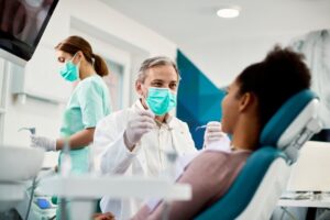 Dentist working with patient. 