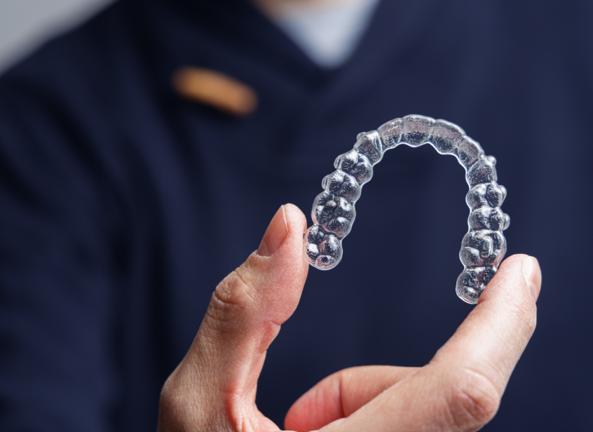 Hand holding clear aligne