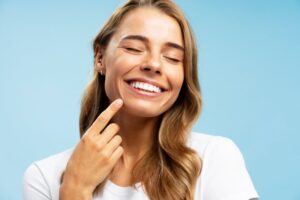 Woman pointing to her straight teeth