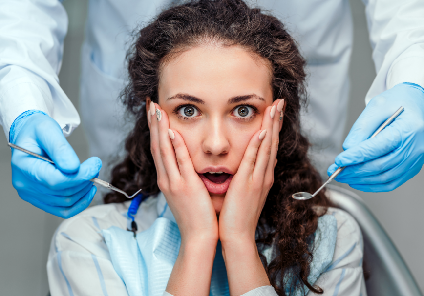 Patient in dental chair looking shocked